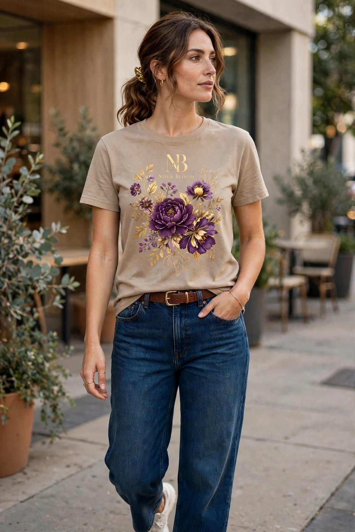 Woman wearing Beige Nova Bloom Royale Floral T-Shirt with gold NB logo on top