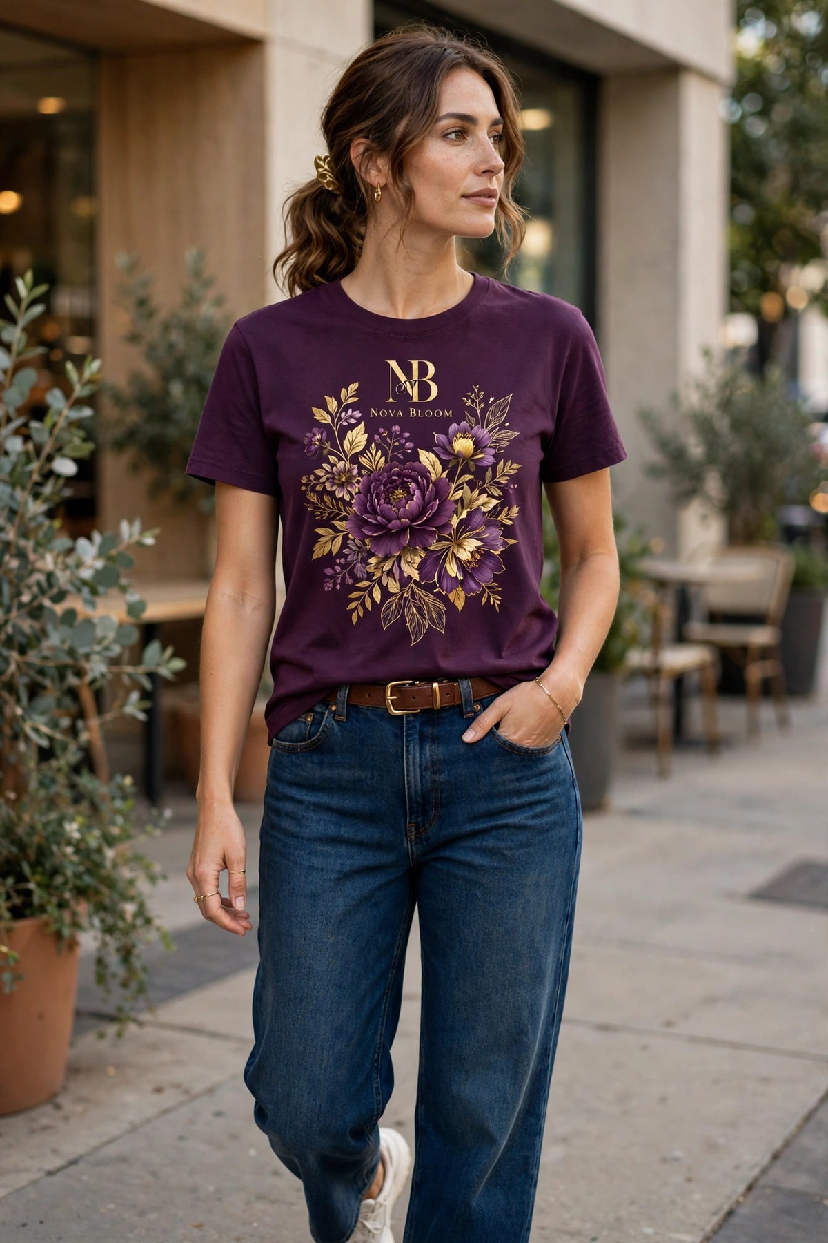 Woman wearing Purple Nova Bloom Royale Floral T-Shirt with gold NB logo on top — chosen picture